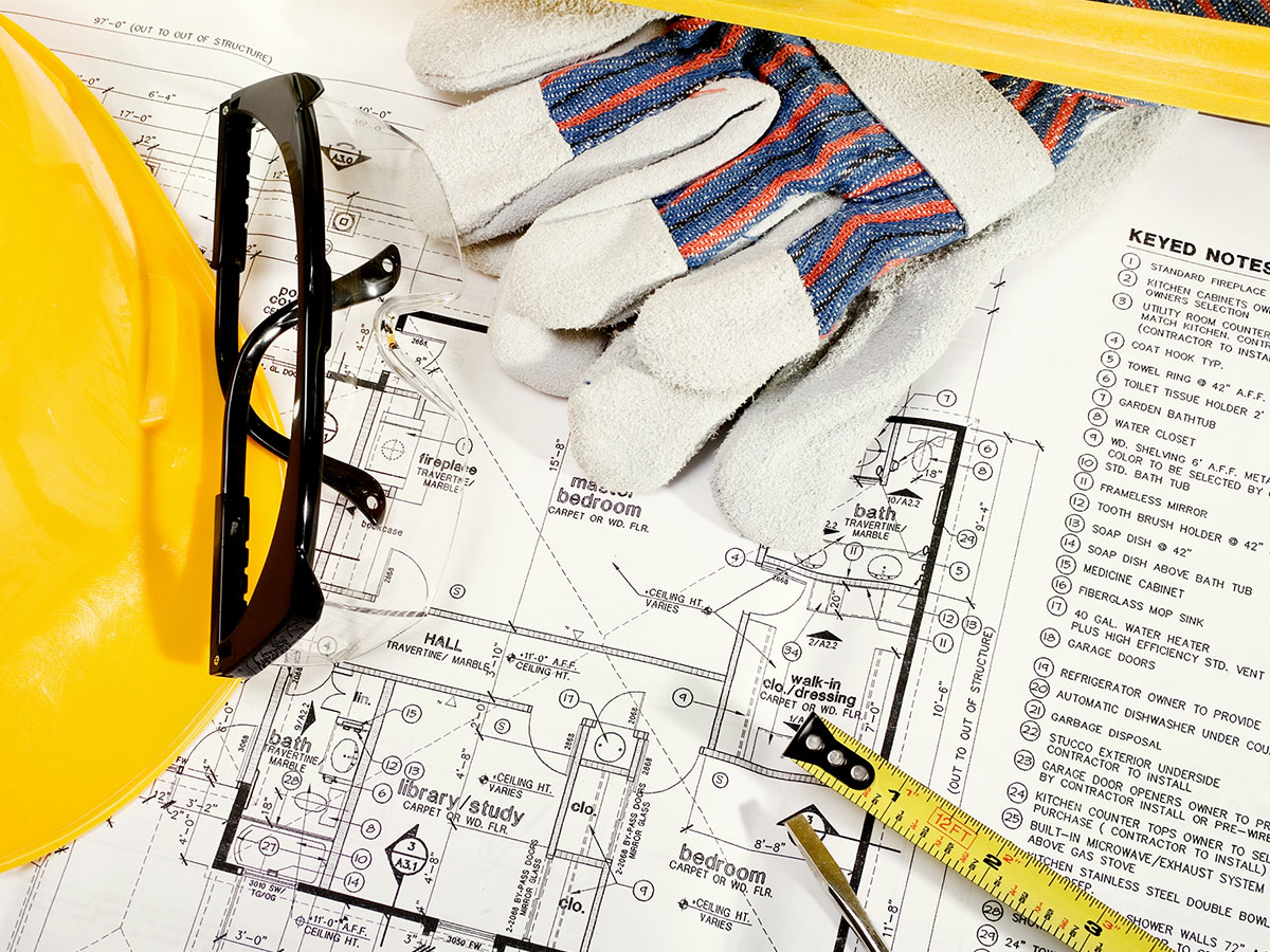blueprint with hard hat measuring tape