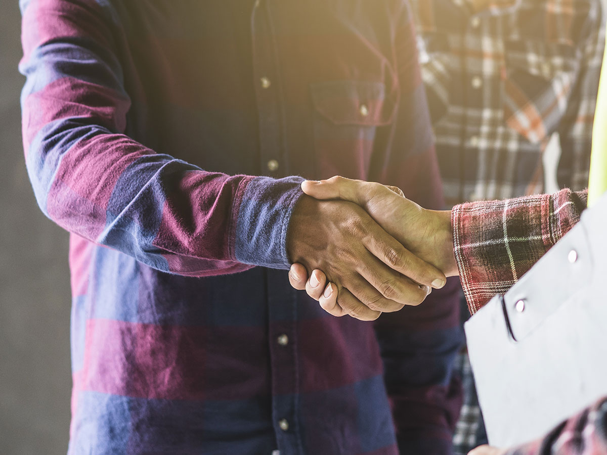 technician and homeowner shaking hands