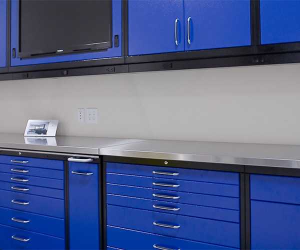 Image of blue custom-made garage cabinets.